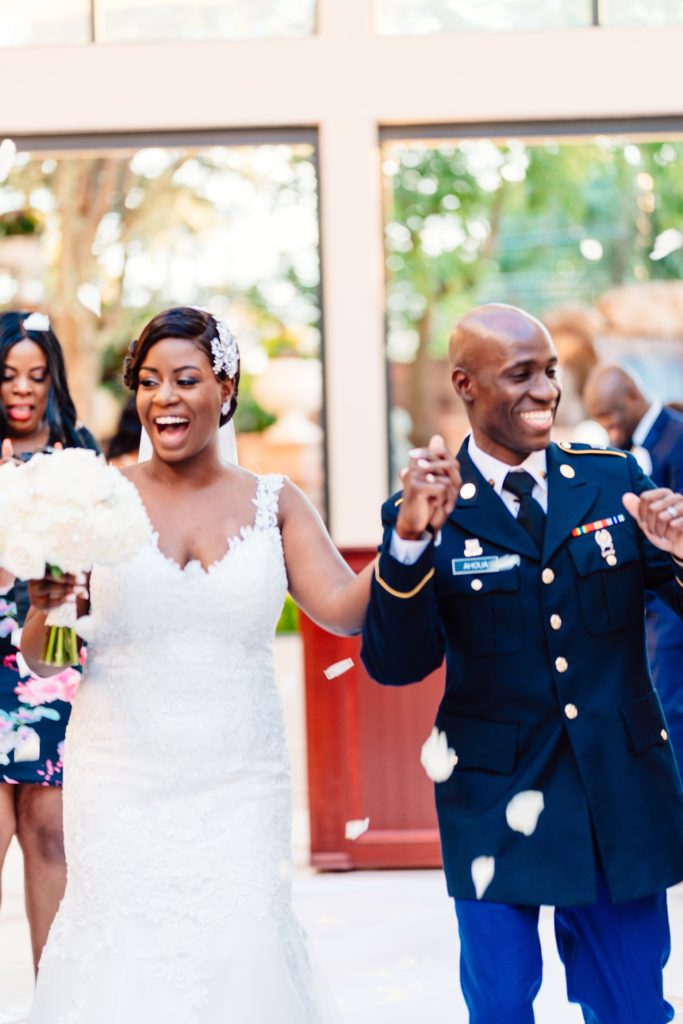 Ivoirian groom and Congolese bride dancing as they leave their wedding ceremony