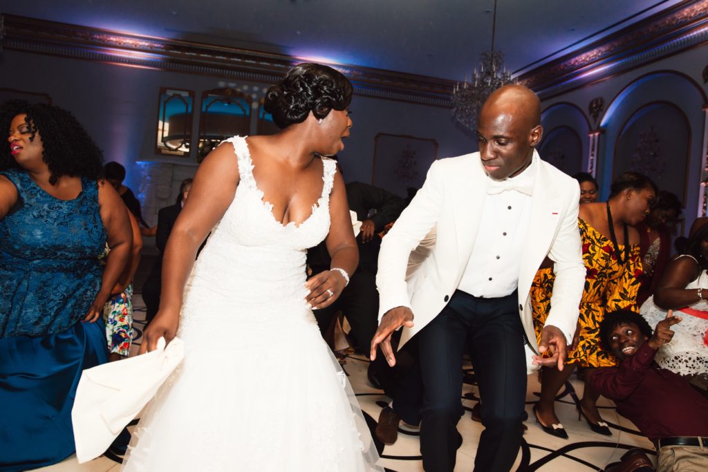 Ivoirian groom and Congolese bride dancing at their wedding reception